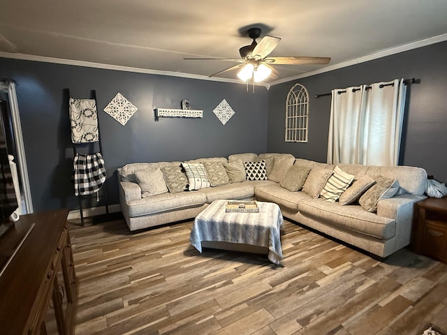 living room featuring crown molding, wood-type flooring, and ceiling fan