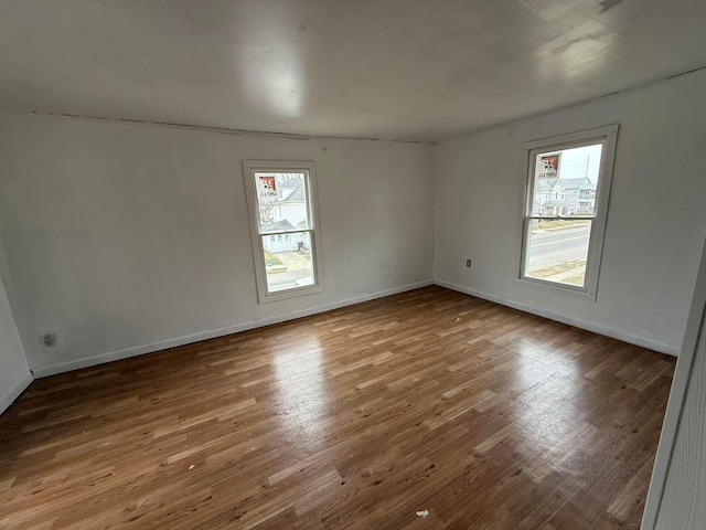 spare room featuring wood-type flooring