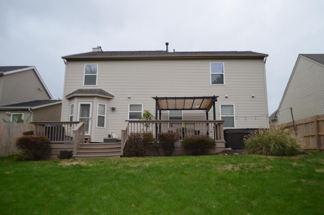 rear view of property with a deck, a lawn, fence, and a pergola