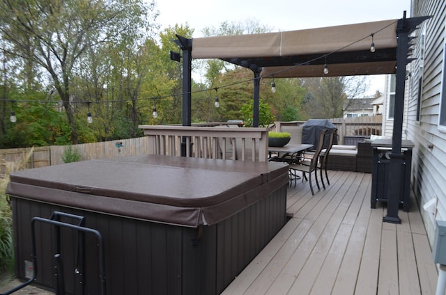 wooden terrace with outdoor dining area and a hot tub