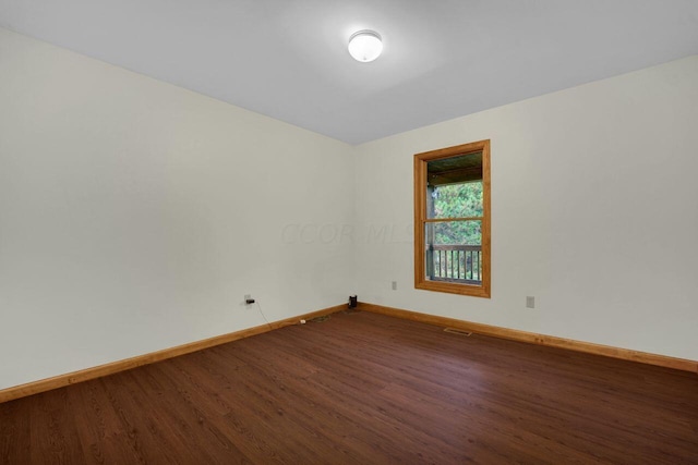 spare room with hardwood / wood-style flooring