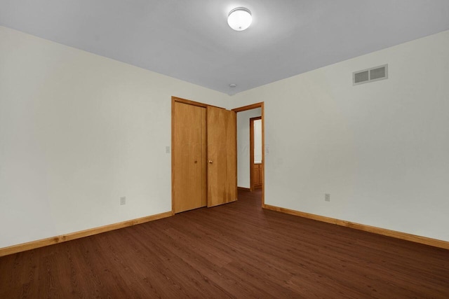 spare room featuring dark hardwood / wood-style floors