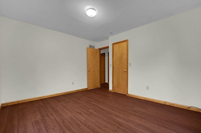 unfurnished room with dark hardwood / wood-style floors