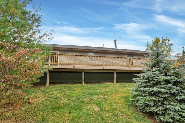 rear view of house with a yard and a deck