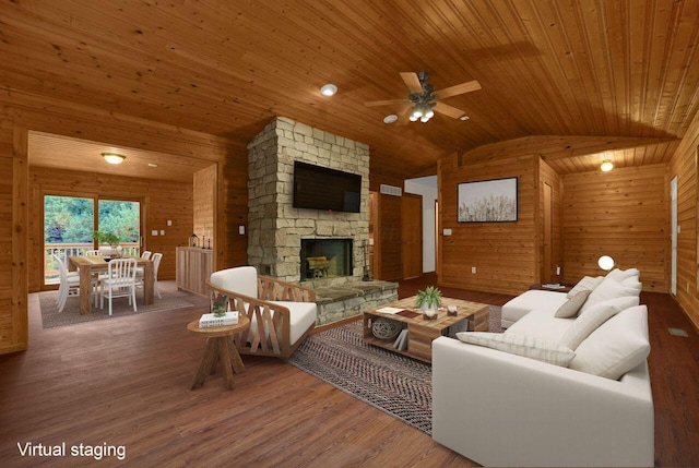 living room with ceiling fan, wooden walls, wood-type flooring, and vaulted ceiling