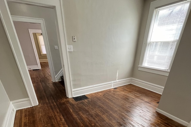 empty room with dark hardwood / wood-style flooring