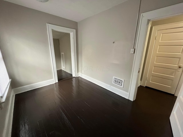 spare room with dark hardwood / wood-style floors