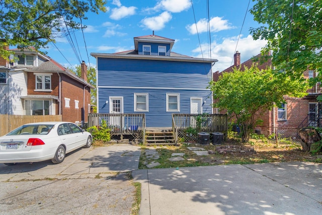 view of front of house with a deck and cooling unit