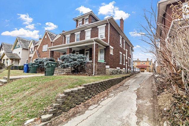 view of front of home featuring a porch and a front yard