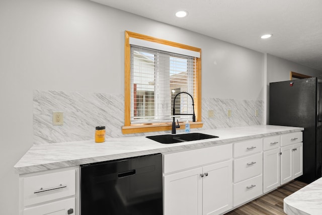 kitchen featuring black appliances, sink, decorative backsplash, dark hardwood / wood-style flooring, and white cabinetry