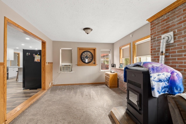 interior space featuring cooling unit, carpet, and a textured ceiling