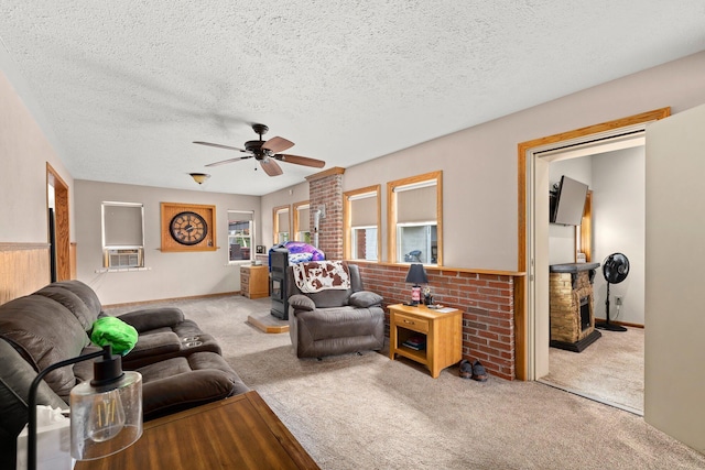 living room with a textured ceiling, light colored carpet, and ceiling fan