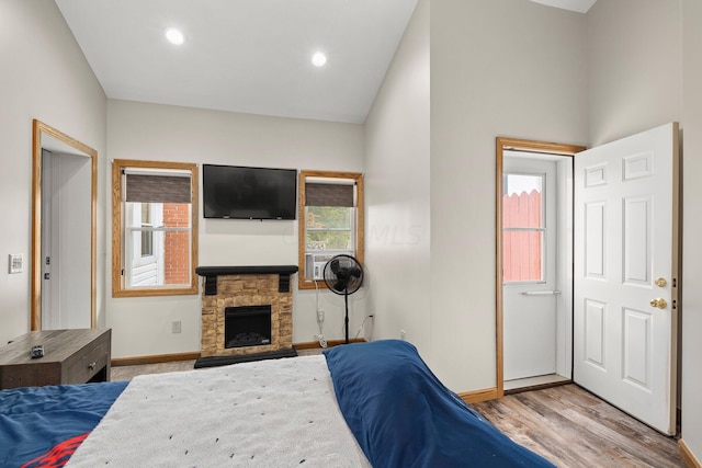 bedroom featuring a fireplace and light wood-type flooring