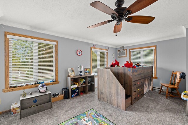 carpeted bedroom featuring ceiling fan, crown molding, a textured ceiling, and a baseboard heating unit