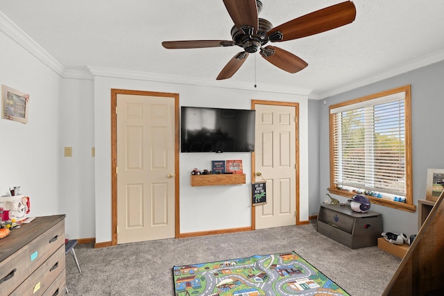 recreation room featuring crown molding, carpet, a textured ceiling, and ceiling fan