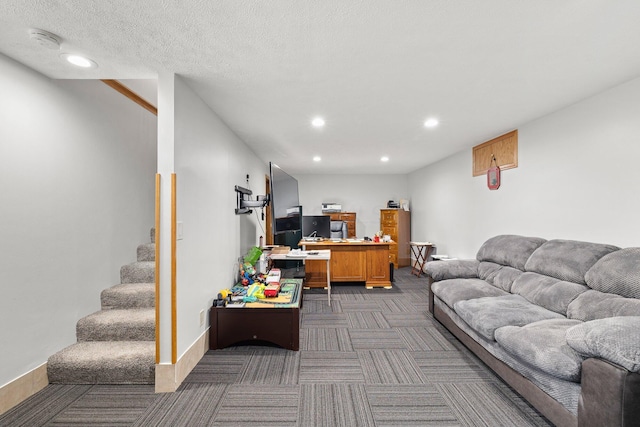 living room featuring a textured ceiling and dark colored carpet