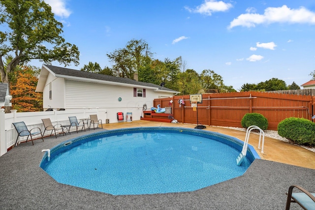 view of swimming pool with a wooden deck