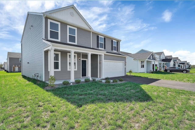 view of front of home featuring a front lawn, a porch, and a garage