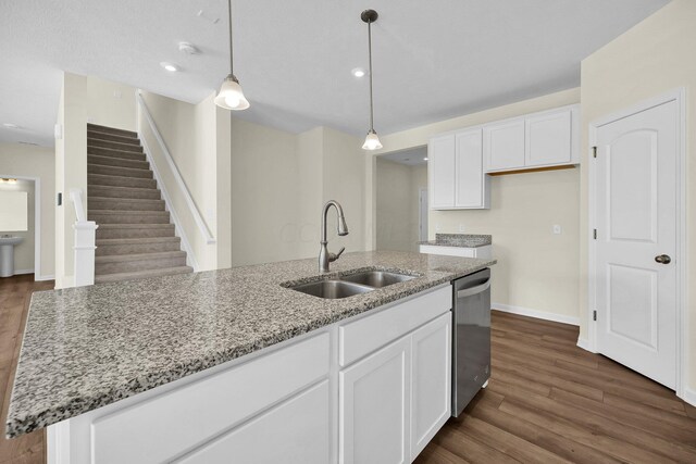 kitchen with a center island with sink, dark hardwood / wood-style floors, white cabinetry, and sink