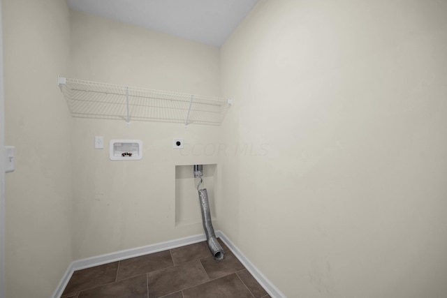 clothes washing area featuring dark tile patterned floors, washer hookup, and hookup for an electric dryer