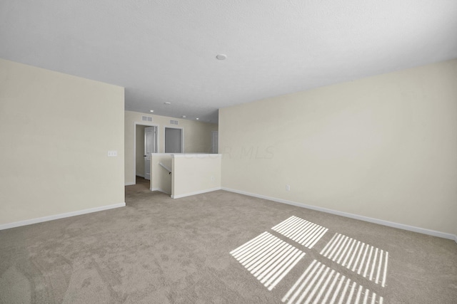 empty room featuring light colored carpet