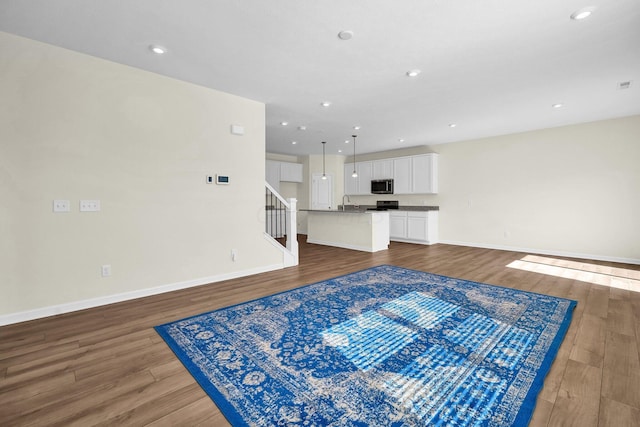 unfurnished living room featuring dark hardwood / wood-style floors