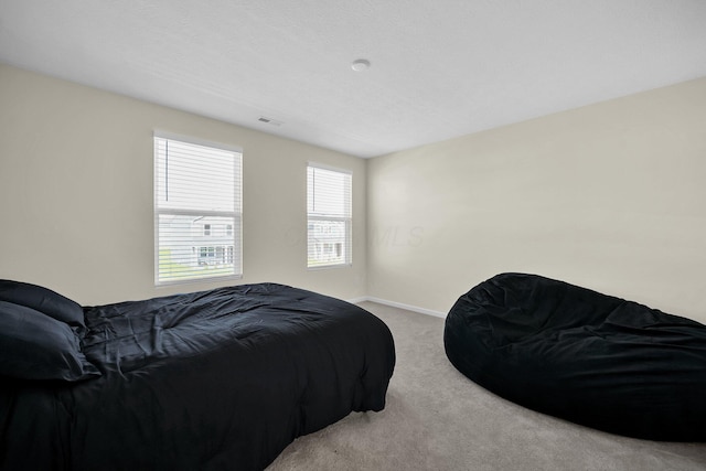 bedroom featuring light carpet