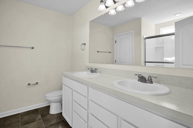 bathroom featuring tile patterned flooring, vanity, toilet, and a shower with door