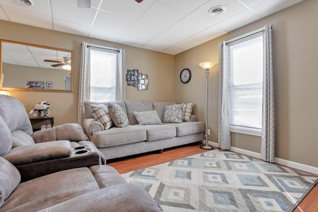 living room featuring a wealth of natural light, ceiling fan, and light hardwood / wood-style floors