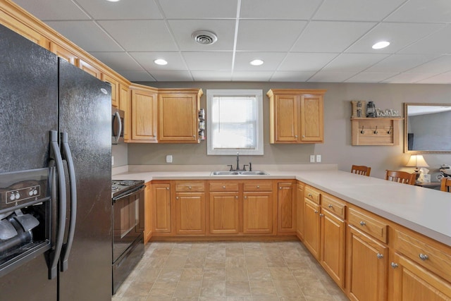 kitchen with kitchen peninsula, sink, a paneled ceiling, and black appliances