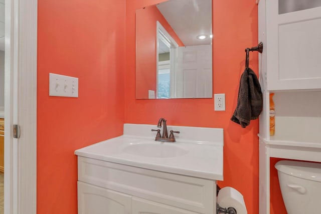 bathroom featuring vanity and toilet