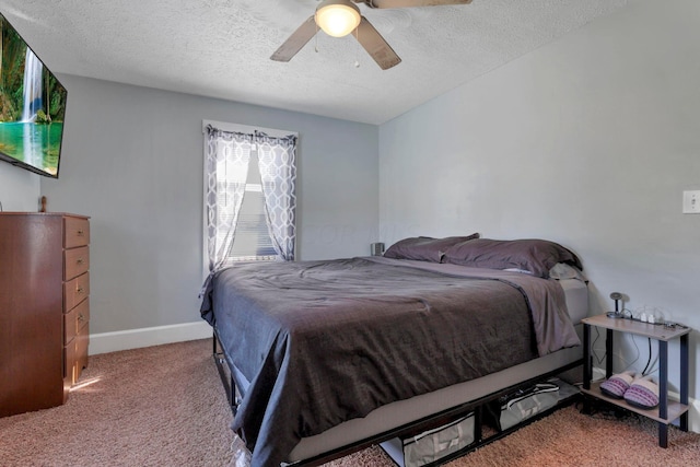 carpeted bedroom featuring ceiling fan and a textured ceiling