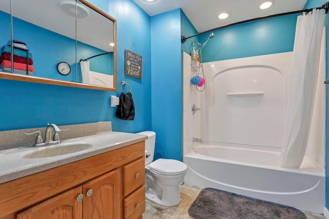 full bathroom with vanity, shower / bath combination with curtain, and toilet