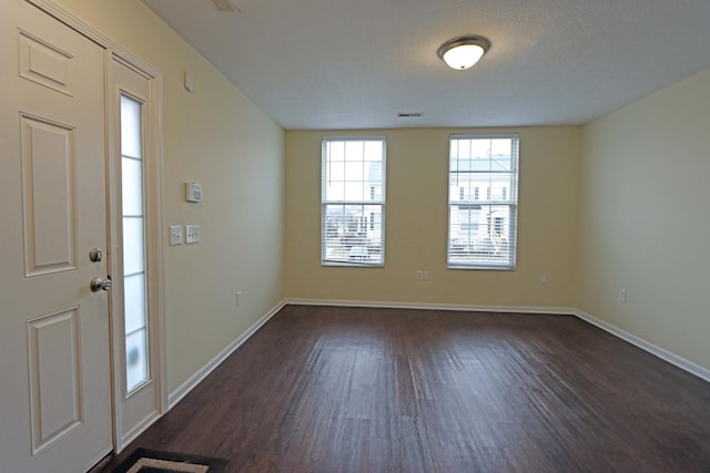 entrance foyer featuring baseboards and dark wood-type flooring