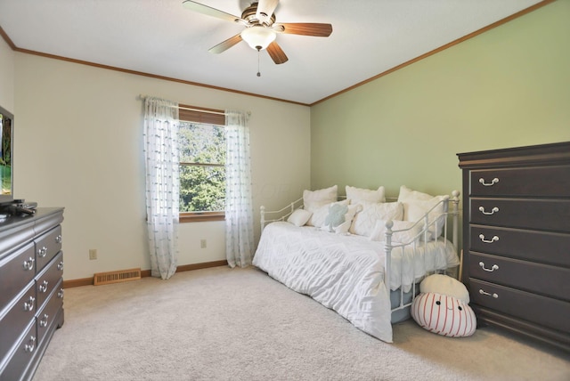 bedroom featuring light colored carpet, ceiling fan, and crown molding