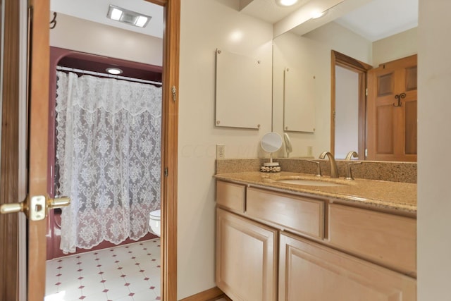 bathroom with vanity and toilet