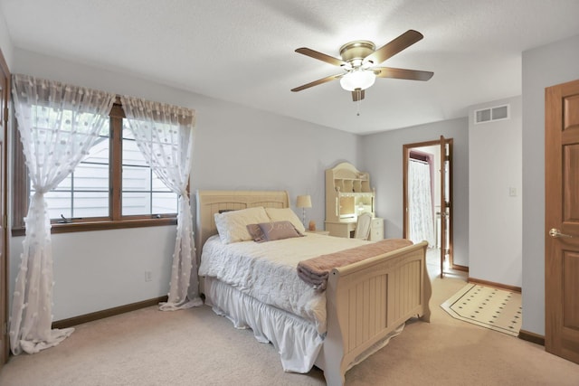 bedroom featuring ceiling fan and light carpet