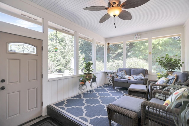 sunroom / solarium featuring ceiling fan