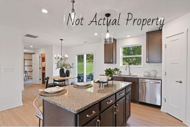 kitchen with dishwasher, a center island, sink, and light hardwood / wood-style flooring