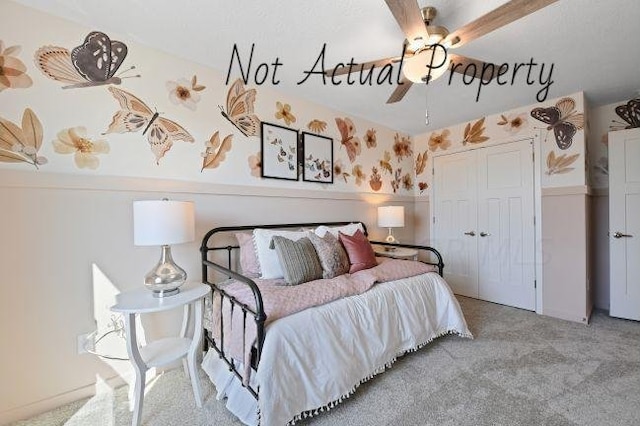 bedroom with ceiling fan, light carpet, and a closet