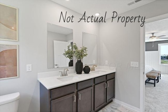 bathroom featuring ceiling fan, toilet, and vanity