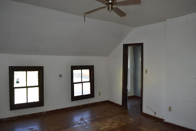 unfurnished room featuring dark hardwood / wood-style floors, vaulted ceiling, and ceiling fan