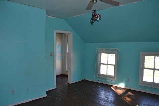 interior space with dark hardwood / wood-style floors, ceiling fan, and vaulted ceiling