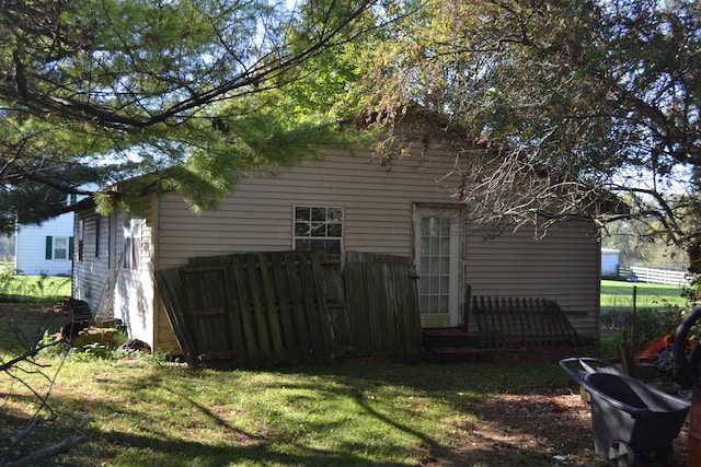 view of side of home with a yard