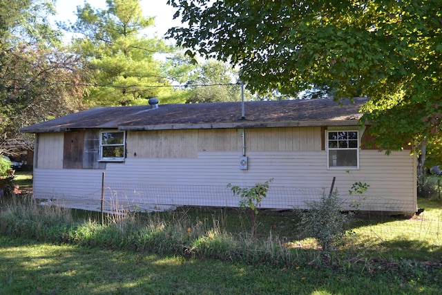 view of side of home featuring a lawn