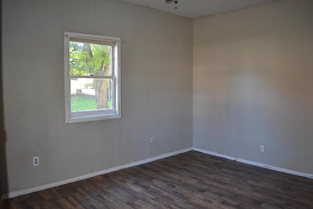 spare room with ceiling fan and dark hardwood / wood-style floors