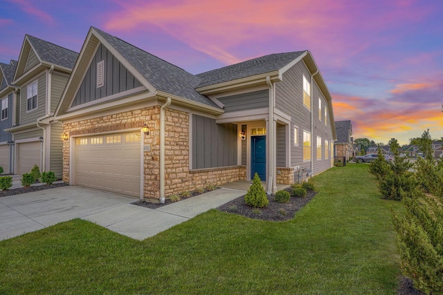 view of front of house with a yard and a garage