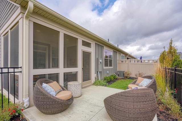 view of patio / terrace featuring central air condition unit and a sunroom