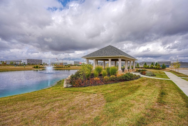 exterior space with a gazebo, a lawn, and a water view