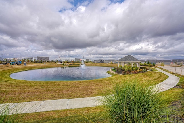 view of community with a gazebo, a water view, and a lawn